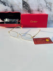 Gold rectangular eyeglasses with clear lenses - flat lay with Cartier card