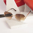 Rimless gold panther brown gradient sunglasses - flat lay with Cartier cleaning cloth on marble