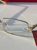 Gold rectangular eyeglasses - front view on marble surface