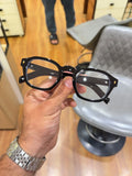Prada Classic Black Gold Eyeglass Frame - Front View with Clear Lenses