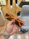 Ray-Ban RB2507S Orange Brown - Side temple view showing vibrant orange arms with Ray-Ban script logo and silver rivet hinge