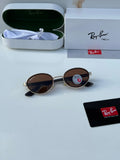 Ray-Ban x Ferrari RB8206 Gold Brown - Hand holding folded frame showing carbon fibre temple arms and gold oval frame